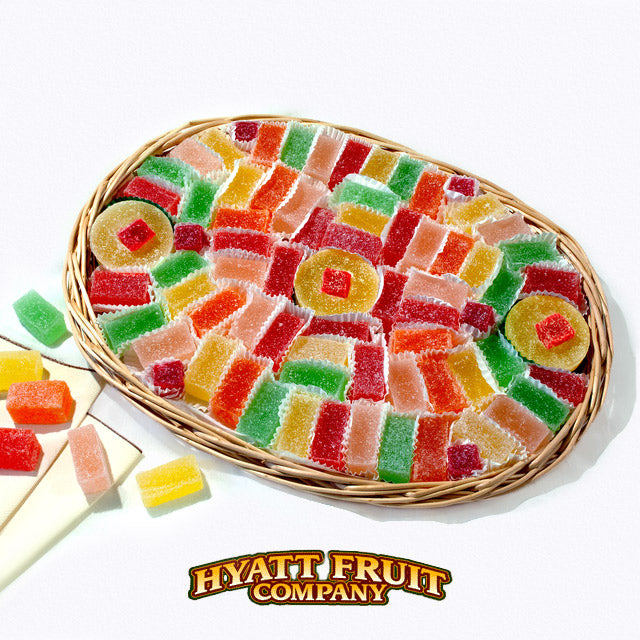 Colorful gummy candy in a wicker basket with Hyatt Fruit Company logo.