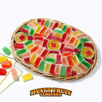 Colorful gummy candy in a wicker jellies gift basket with Hyatt Fruit Company logo.