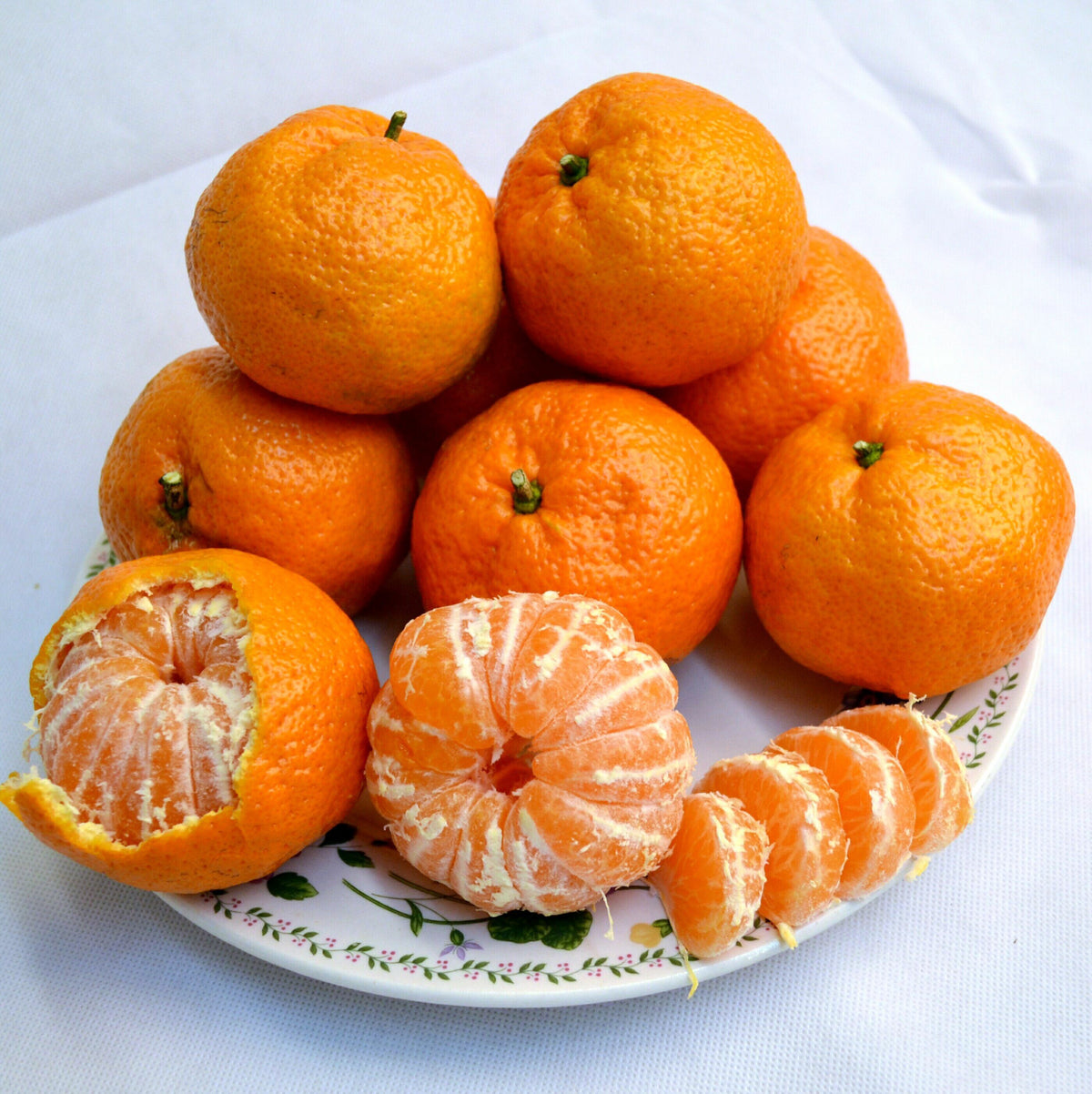 The Satsuma Mandarin arranged on a plate, showcasing their vibrant orange color and sweet, juicy segments.